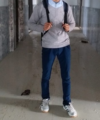 Ahmad standing, on his way to work